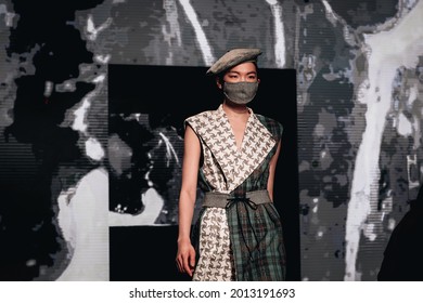 MOSCOW RUSSIA - October 17 2018: Asian Model In A Protective Mask On Face And Beret Walks The Runway Fashion Show During Mercedes-Benz Fashion Week Russia