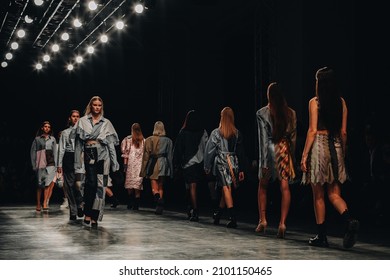 MOSCOW RUSSIA - October 20 2021: Fashion Models In A Stylish Designer Outfit Walking The Final Catwalk At A Fashion Show. Fashion Week Inspiration. Models In A Row