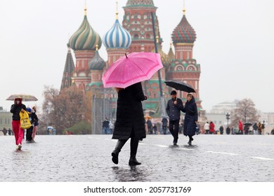 Moscow, Russia - October 2021: People With Umbrellas Walking On The Red Square On Background Of St. Basil's Cathedral. Rain In City, Fall Season