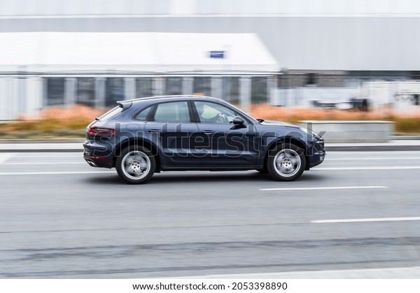 Moscow, Russia - October 2021: Porsche Macan\
Turbo on the route in motion, side\
view.
