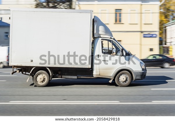 Moscow, Russia - October 2021: Small cargo van\
GAZ Gazelle speeding on the street. Russian light commercial\
vehicle in motion.