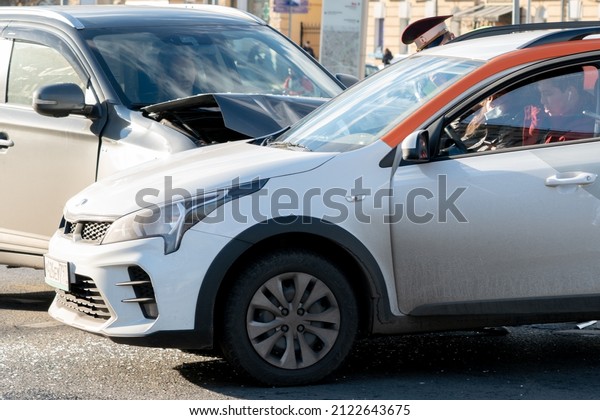 Moscow, Russia, October 23, 2021. Drivers are\
sitting inside cars that have just collided on the road. An\
accident with a car-sharing car in the\
city.