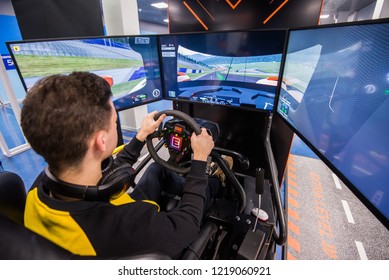 MOSCOW, RUSSIA - OCTOBER 27 2018. Simulation Of Race Car Video Player Game With Big Screen Monitors And Cockpit Controls Like A Racing Car.