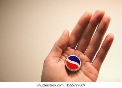MOSCOW / RUSSIA - OCTOBER 29, 2019: Pepsi Cola bottle cap in the hand