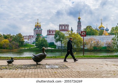 MOSCOW, RUSSIA - OCTOBER 5, 2021:  A man passing by the sculptural composition Make way for ducklings near Novodevichy convent. Gift of Barbara Bush to Soviet children 