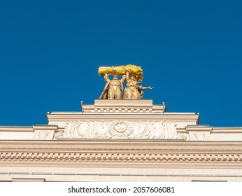 Moscow, Russia - October 5, 2021: Arch of the main entrance of VDNKh. A sculpture of a tractor driver and a collective farmer is installed on the roof of the arch. Close-up, bottom view.
