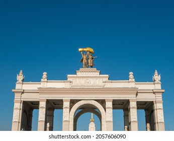 Moscow, Russia - October 5, 2021: Arch of the main entrance of VDNKh. Sculpture of a tractor driver and a collective farmer is installed on the roof of the arch. Close-up.