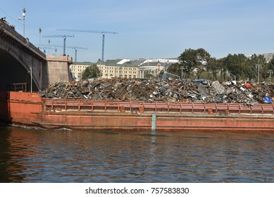 MOSCOW, RUSSIA - SEPT 17, 2017: Pushed barge full of industrial trash being transported on Moscow river in city center