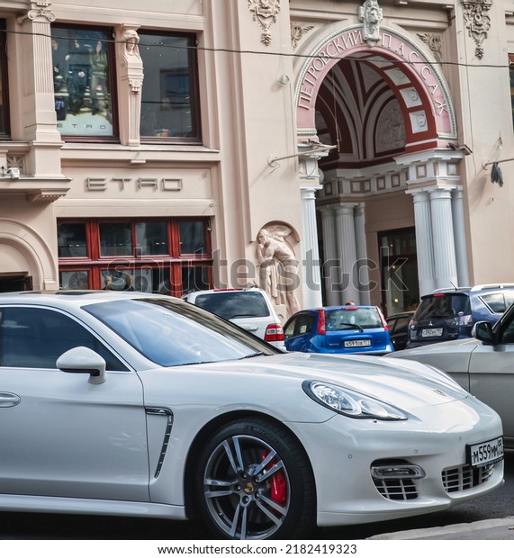 Moscow, Russia -\
September 10 2010 : an expensive modern sports car is parked on a\
typical classical Moscow street showing contrast between old and\
new, poor and rich
