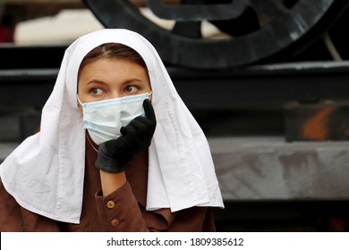 Moscow, Russia - September 2020: Nurse Of Early 20th Century In Face Mask Near The Field Military Hospital During The City Day Of Moscow. Historical Reconstruction Of The World War I, Field Medicine