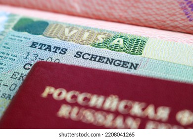 Moscow, Russia - September 2022: A Fragment Of A Schengen Visa Stamp On The Blurred Background Of The Russian International Passport. The Concept Of Sanctions Against Russia.