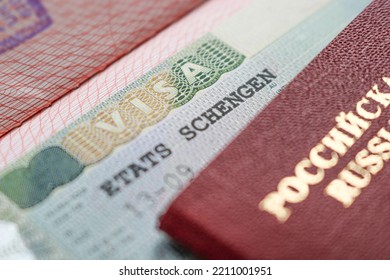 Moscow, Russia - September 2022: A Fragment Of A Schengen Visa Stamp On The Blurred Background Of The Russian International Passport. The Concept Of Sanctions Against Russia. Selective Focus