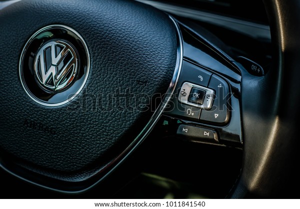 MOSCOW, RUSSIA - SEPTEMBER 22, 2017 VOLKSWAGEN TIGUAN\
crossover car SUV manufactured by Volkswagen, steering wheel with\
VW logo interior view.Volkswagen close up logo. Volkswagen car logo\
bage. 