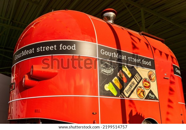 Moscow, Russia - September\
8, 2022: Red wagon truck selling street food in the urban center of\
Moscow. 
