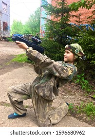 Moscow.  Russia.  Summer 2019. Girl Soldier.  Baby Girl Girl In Camouflage Uniform With A Gun.  Children's Military Quest.  War Games For Children.  Patriotism.  Laser Games Outdoor