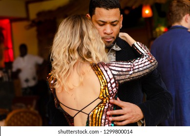 Moscow, Russia-January 19, 2019: A Middle-aged Couple, A Man And A Woman, Dance Salsa Among A Crowd Of Dancing People In A Nightclub Tiki Bar. 