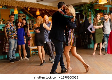 Moscow, Russia-January 19, 2019: A Middle-aged Couple, A Man And A Woman, Dance Salsa Among A Crowd Of Dancing People In A Nightclub Tiki Bar. 