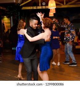 Moscow, Russia-January 19, 2019: A Middle-aged Couple, A Man And A Woman, Dance Salsa Among A Crowd Of Dancing People In A Nightclub Tiki Bar. 