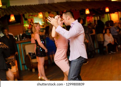 Moscow, Russia-January 19, 2019: A Middle-aged Couple, A Man And A Woman, Dance Salsa Among A Crowd Of Dancing People In A Nightclub Tiki Bar. 