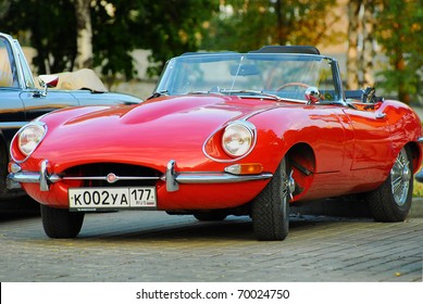 MOSCOW, RUSSIA-JULY 31: Red Jaguar E-Type. Modelyear 1963, on exhibition parking at annual 'Night Moscow Classic Rally'. The sixth race of vintage cars, more than 50 crews, from owners to showstars