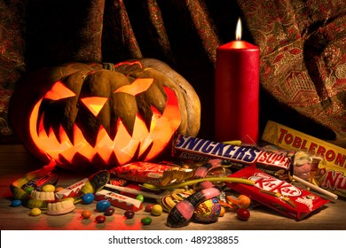 Moscow, Russian Federation. December 24, 2015. Halloween Pumpkin And Many Candy Bars. Spooky Jack-o'-lantern