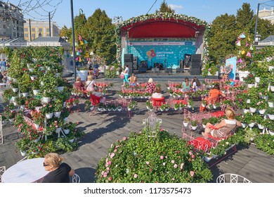 MOSCOW, SEP. 02, 2018: View On Beautiful Flower Beds, Small Music Stage, People On Benches On Street Festival Flower Jam