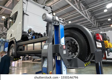 MOSCOW, SEP, 4, 2019: View On Commercial Truck Under Maintenance On Electric Lift. Truck Workshop Equipment, Tools For Car And Truck Chassis Maintenance And Repair Works. Lifted Car Under Inspection