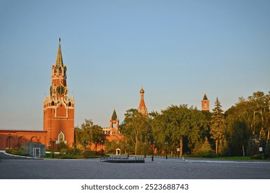 Moscow. Spasskaya Tower with a clock inside the Kremlin walls at sunset. - Powered by Shutterstock