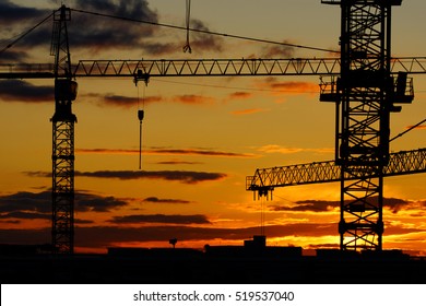 Moscow. Sunset in the city. Construction. The elevating cranes on the sunset background. - Powered by Shutterstock