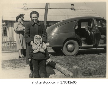 MOSCOW, USSR - CIRCA 1960s : An Antique Photo Shows Soviet Family And Their Car. 