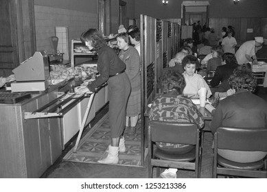 Moscow, USSR - November 23, 1989: Canteen in the Ministry of the Automotive Industry of the USSR. On the left employees standing in line to pay for food. On the right they have dinner or lunch.