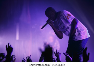 MOSCOW-15 NOVEMBER,2016:Famous Rap Band Asap Mob Performing Live Hip Hop Music Show On Nightclub Stage.Black Rapper Singer With Microphone On Scene.Concert In Crowded Nightclub.Music Fans Put Hands Up