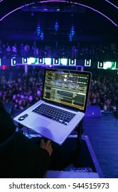 MOSCOW-15NOVEMBER,2016: Edm Dj Music Festival Background.Party Dj Play Music On Stage In Big Night Club.Bright Blue Stage Lighting.View From Stage On Rave Concert Crowd.Concert Dj Play Music On Laptop