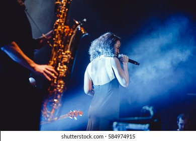 MOSCOW-1,MARCH 2015:Popular Live Music Band De Phazz Plays Acid Jazz Concert In Big Nightclub.Musician Perform On Scene In Bright Lights.Night Club Music Show.Female Singer With Microphone