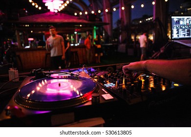 MOSCOW-2 JUNE,2016:DJ Plays Music.Hip Hop Party In Night Club.Professional Disc Jockey Audio Equipment On Stage.Turntables Vinyl Records Player & Sound Mixer Controller In Bar