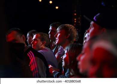 MOSCOW-31 MARCH,2016: Concert crowd audience in music hall.Young boy listen to favorite music in bright red stage concert lighting.Music festival,crowded concert dance floor.Young man enjoy festival - Shutterstock ID 401880568