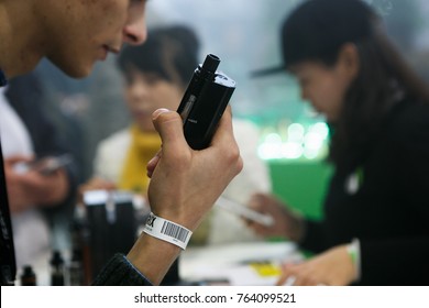 MOSCOW-6 DECEMBER,2016:Vape Expo Event.Exposition Of Modern Electronic Cigarettes,vape Juice Liquid And Gadgets.Man Holds New Vaping Device