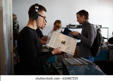 MOSCOW-6 MARCH,2017: Music Lover Listening To Rare Vinyl Records In Dj Shop.Hipster Sound System.Hipster Man Listen To Vintage Vinyl Record With Music In Dj Store.Music Store Dj Vinyl Collection Sale