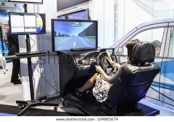 MOSCOW-June 1: Woman driving training simulator at\
the international exhibition of navigation equipment and software\
Navitech on June 1, 2011 in\
Moscow