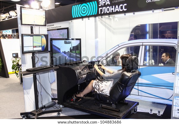 MOSCOW-June 1: Woman driving training simulator at\
the international exhibition of navigation equipment and software\
Navitech on June 1, 2011 in\
Moscow
