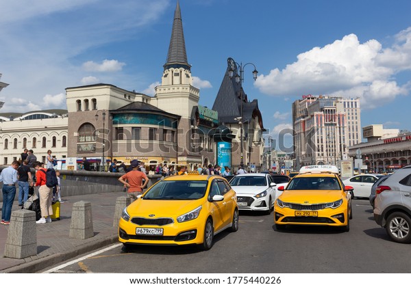 Moscow/Russia - 07.12.2020: Three stations\
square. Yaroslavsky train station. On a sunny day taxi cabs\
entering parking space in front of the railroad station to pick up\
arriving city\
visitors.