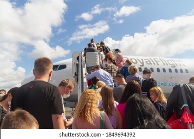 Moscow/Russia - 08 12 2020: The Plane Ramp Is Lowered, People In Medical Masks Climb On The Plane, Without Observing The Social Distance.