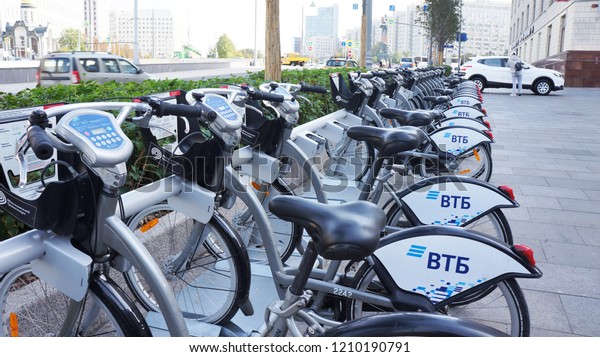  Moscow/Russia - October 2, 2018: Bicycle rental in\
the center of Moscow. Moscow car sharing. City bikes for rent  at\
automatic rental station in Moscow. People use Credit Card of Smart\
Card.         