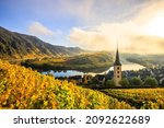The Moselle loop, a beautiful river in Germany, makes a 180 degree loop. with vineyards and a great landscape and lighting in the morning. the church tower and the town of Bremm in autumn