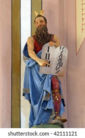 Moses holding the Ten Commandments.