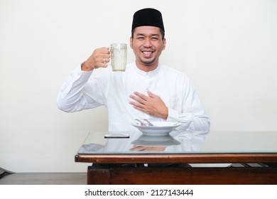 Moslem Asian Man Smiling While Going To Drink A Glass Of Water For Break Fasting