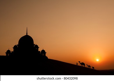 mosque in desert with camels silhouette