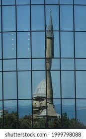 Mosque of the Martyrs in Baku in Azerbaijan Reflected in the Modern Glass Facade of an Office Building - Juxtaposition of Old and New