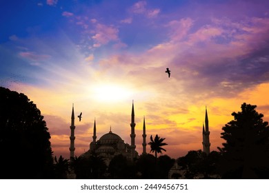 The mosque and minarets against the background of setting the sun. Istanbul, Bosporus. A silhouette of a mosque set against a stunning sunset sky, a serene Islamic Ramadan backdrop