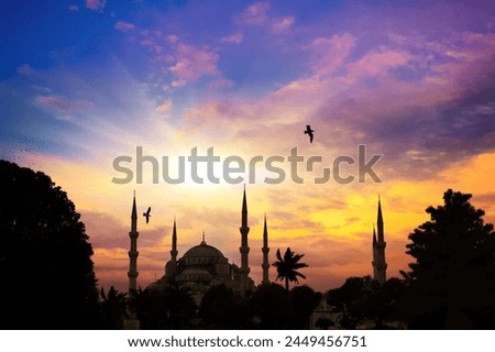 The mosque and minarets against the background of setting the sun. Istanbul, Bosporus. A silhouette of a mosque set against a stunning sunset sky, a serene Islamic Ramadan backdrop
